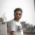 Photo by Adib Hussain man in white crew neck t-shirt wearing black sunglasses